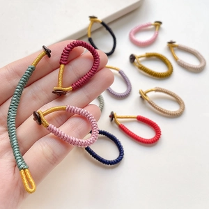 Handmade woven cord ring accessory with colorful silk knots and fastener detail