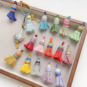 Handmade woven tassel charms in various colors for DIY crafts and ethnic accessories