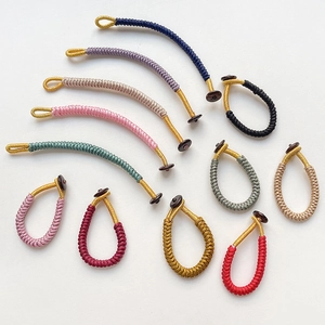 Handcrafted woven rope keychains in multiple vibrant colors with gold thread detail