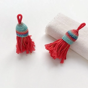 Detail of red handmade woven tassels with decorative silk thread knots and hanging loops