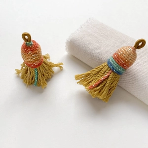 Detailed close-up of handmade woven tassel pendants in vibrant multi-color folk style