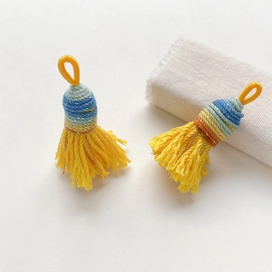 Close-up of handmade yellow woven tassels with colorful ethnic style decorative knots