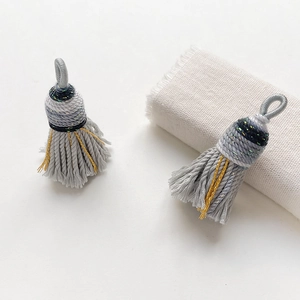 Close-up of grey woven tassels with metallic gold thread for DIY jewelry accessories