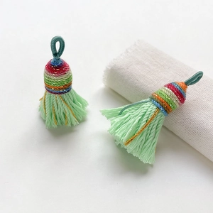 Close-up of handmade ethnic braided tassels with colorful silk threads for DIY crafts