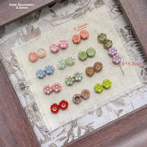 Macro detail of 8.5mm floral glass beads showing various colors and 0.8mm hole size