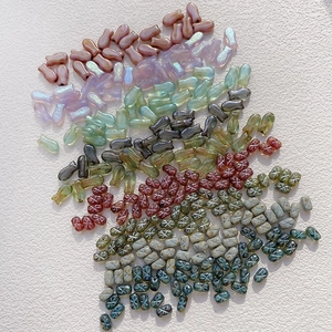 Detail of Czech glass fish beads and vintage patterned oval spacers for DIY jewelry making