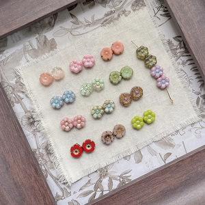 Detailed macro view of Czech glass flower beads with elegant gold-painted edges for DIY jewelry