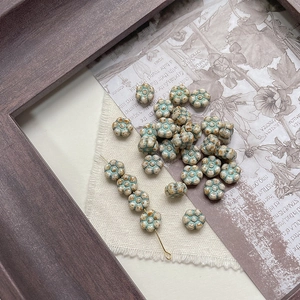 Macro detail of Czech glass flower beads with vintage Picasso glaze and center holes