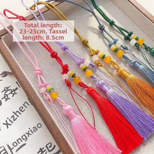 Detail of colorful silk tassels with beaded knots and length dimensions 23-25cm