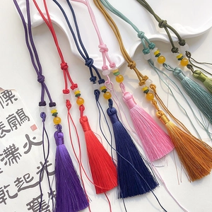 Selection of handmade silk tassels in vibrant colors with traditional woven bead accents