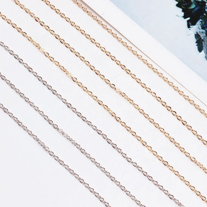 Detailed close-up of DIY O-link jewelry chains in polished gold and silver finishes