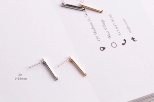 Macro detail of 2x19mm rectangular earring posts in silver and rose gold for DIY jewelry