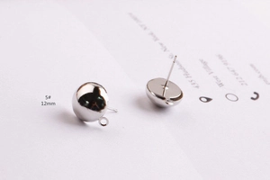 Close-up of 12mm silver hemispherical earring studs with loops for DIY jewelry making
