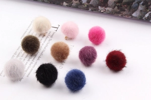 Detailed view of ten colorful faux mink fur pompom charms with golden metal loops for DIY