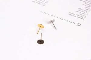 Flat round pad earring posts in gold, silver, and bronze finishes for DIY jewelry