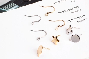 Detail of gold and silver DIY jewelry accessories with stars and round stud earring bases