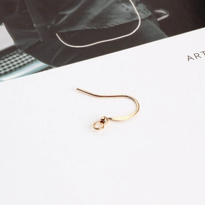 Macro shot of gold-plated earring hooks with ball detail for DIY jewelry making