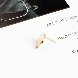 Detail of gold-plated circular stud earrings with hanging loop for DIY jewelry making