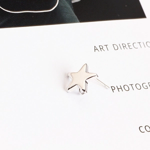Macro shot of silver star-shaped earring studs with connection loop for DIY jewelry
