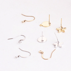 Macro view of gold and silver plated DIY earring components with star and round studs