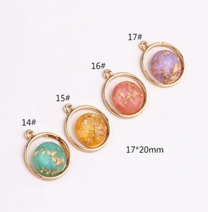 Detail of 17x20mm geometric alloy charms with gold foil resin inlay for DIY jewelry