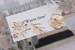 Detailed view of 18K gold plated peacock and branch charms for DIY jewelry making