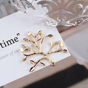 Detailed close-up of 18K gold-plated peacock branch pendant for DIY jewelry making