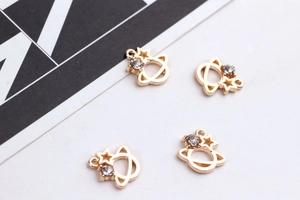 Detail view of 4-piece DIY gold alloy star and planet pendants with inset rhinestones