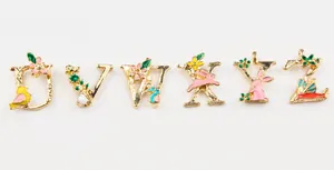Macro shot of U to Z enamel flower alphabet charms with gold alloy hooks for DIY jewelry