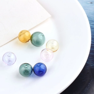 Close-up of multicolored transparent hollow glass beads with double-hole for DIY jewelry