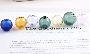 Close-up of assorted colorful transparent glass beads with dual holes for DIY jewelry