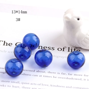 Macro detail of 13x14mm hollow transparent glass beads in deep blue-purple for DIY crafts