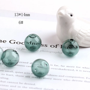 Detailed view of 13x14mm dark green hollow glass beads for DIY jewelry making