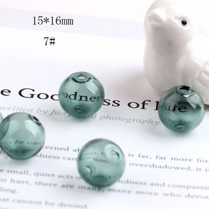 Macro shot of a 15x16mm dark green hollow glass sphere bead for DIY jewelry making