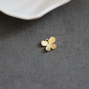 Golden butterfly charm with mesh texture and hanging loop for DIY jewelry making