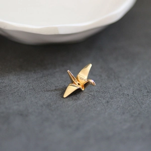 Minimalist gold origami crane charm made of high-quality copper with realistic folds