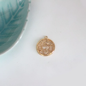 Macro detail of a gold-plated circular hollow pendant for DIY jewelry making and craft