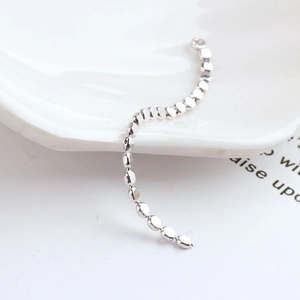 Close-up of flat oval metal bead chain in silver finish for DIY jewelry making