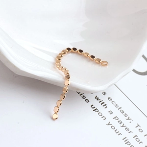 Macro detail of 18K gold plated flat round bead chain for DIY jewelry earring making