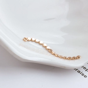 Macro detail of 18K gold plated flat round bead chain for DIY jewelry making material