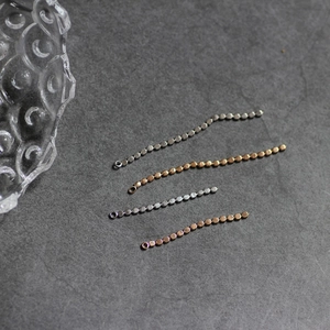 Macro detail of 18K gold plated beaded chain tassels for DIY jewelry earring making
