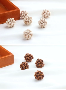 Close-up of handmade woven round wood beads for DIY summer jewelry making earrings
