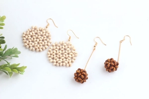 Handmade bohemian summer earrings set featuring woven wooden beads and sphere pendants