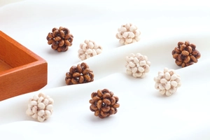 Detail of hand-woven wooden bead balls in dark brown and beige for DIY jewelry crafts