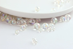 Macro detail of iridescent acrylic round beads with rainbow luster for DIY jewelry