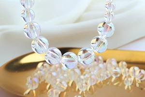 Rainbow acrylic bubble beads for DIY handmade jewelry on elegant silk background