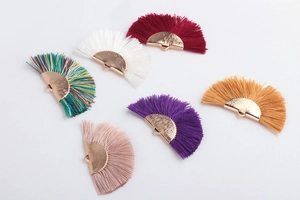 Detail of colorful fan-shaped tassel pendants with gold metal caps for DIY jewelry
