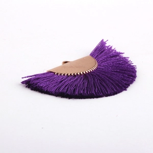 Close-up of purple fan-shaped silk tassel pendant with gold metal cap for DIY jewelry