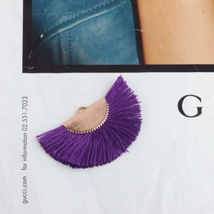Close-up of purple fan-shaped tassel with a golden metal base and small hanging hook