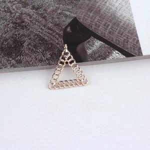 Detailed view of triangular golden alloy pendant made of interlaced rings for DIY jewelry